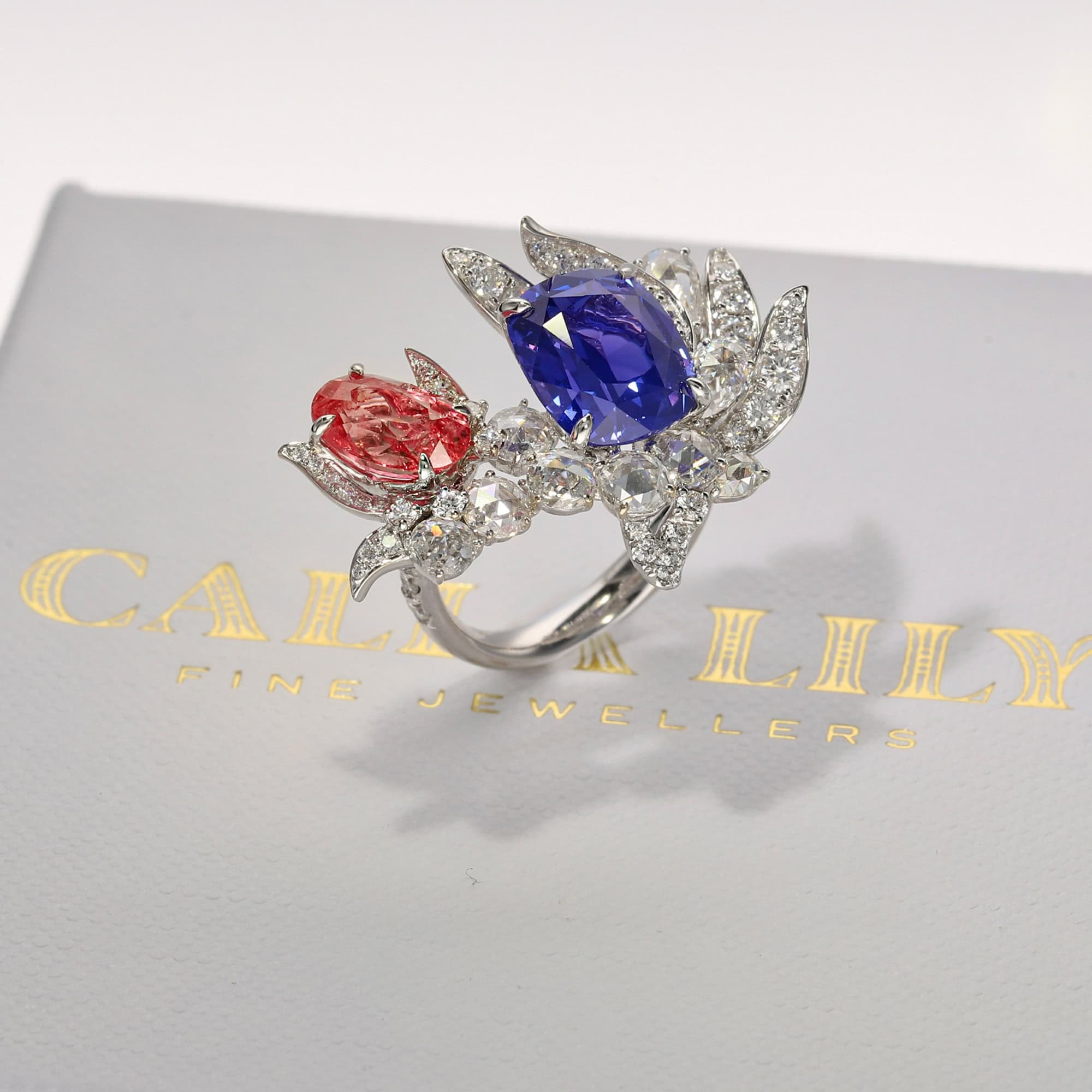 A bespoke creation, entirely unique, featuring a rare coral-hued padparadscha sapphire.