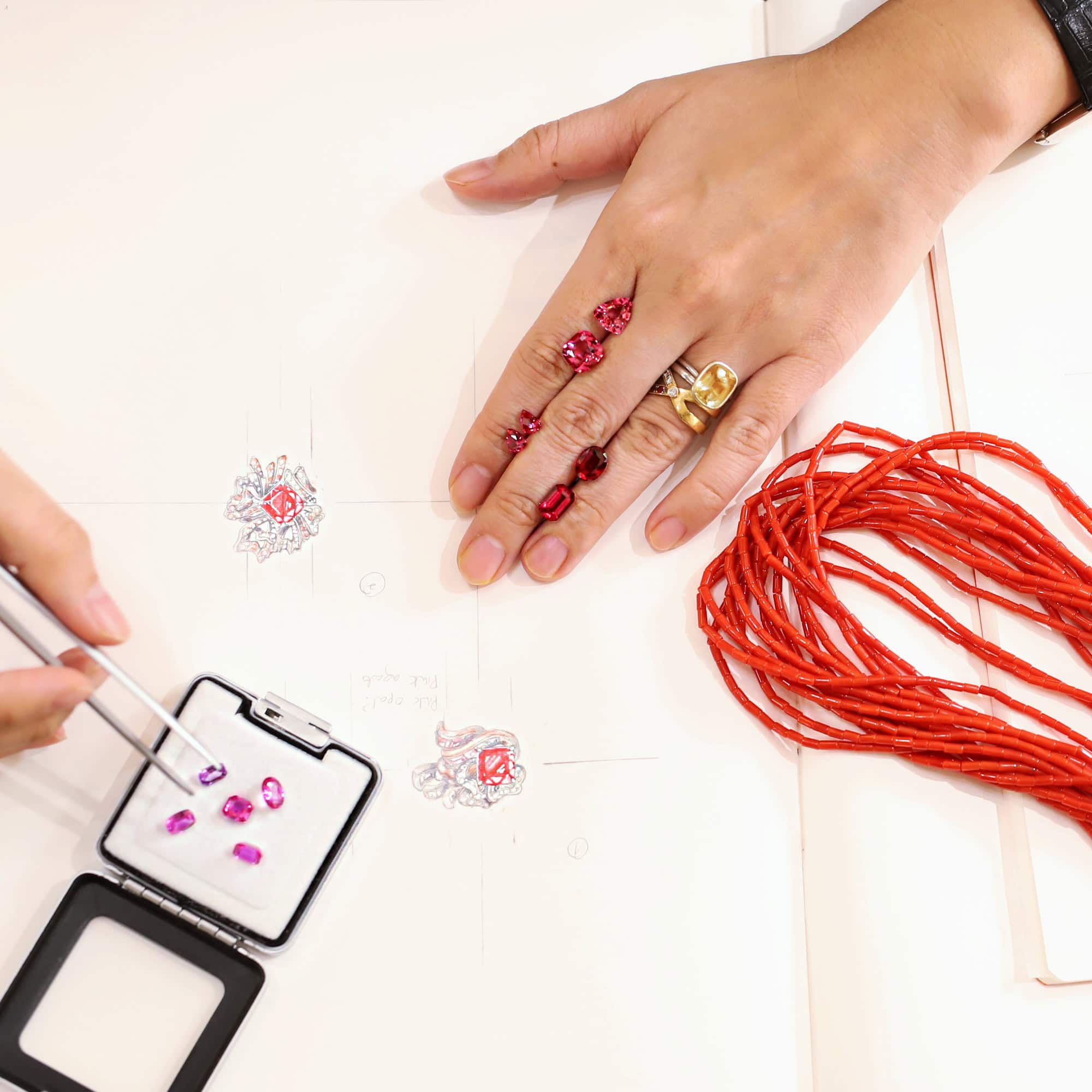 Variety of red and pink gemstones being tested in a new design