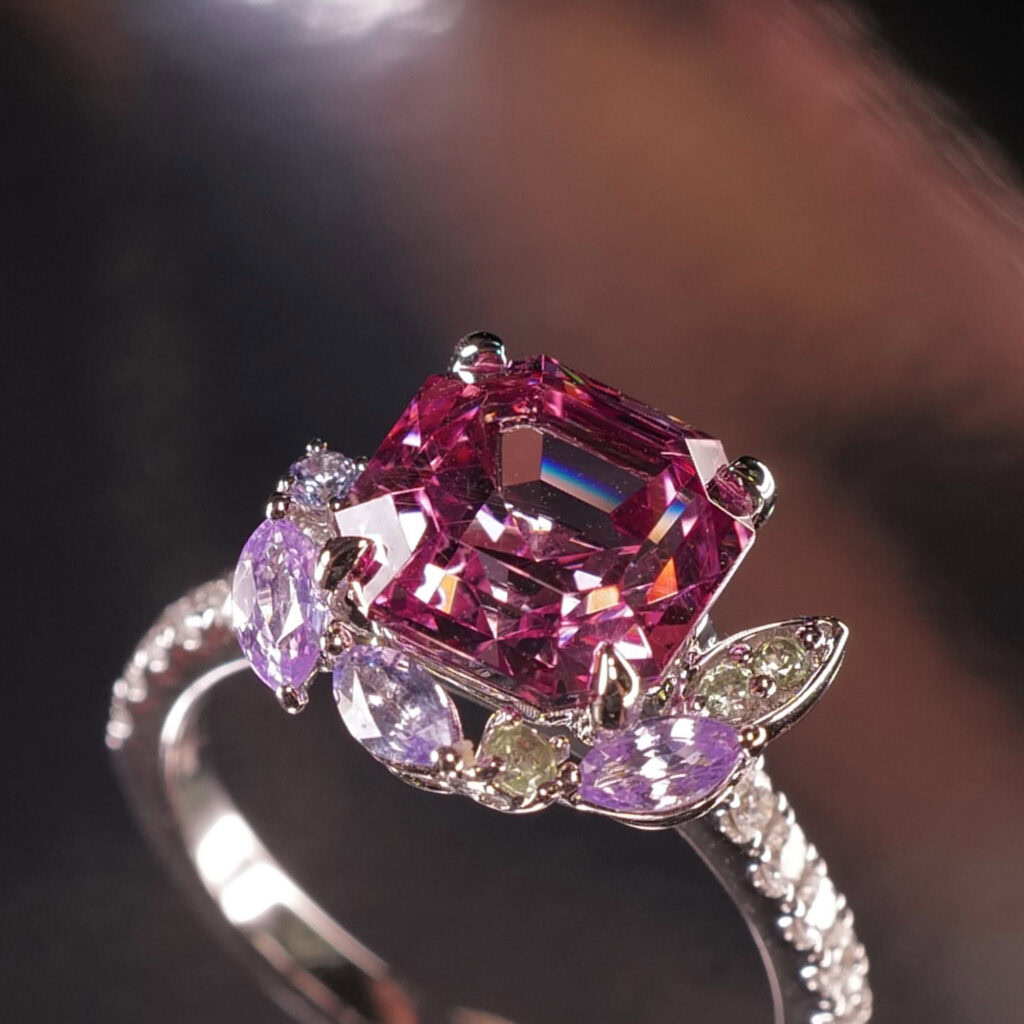 Our classic Ring with Partial Halo, featuring a Malaia Garnet and mixed Sapphires in White Gold